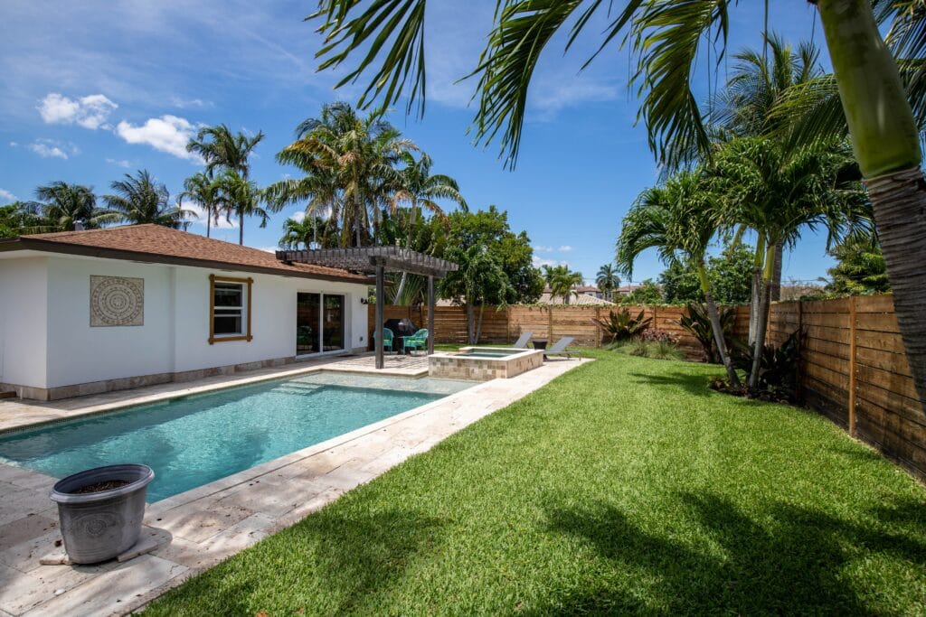 Cape Coral backyard with budget-friendly landscaping including native plants, mulch, and fresh garden beds.