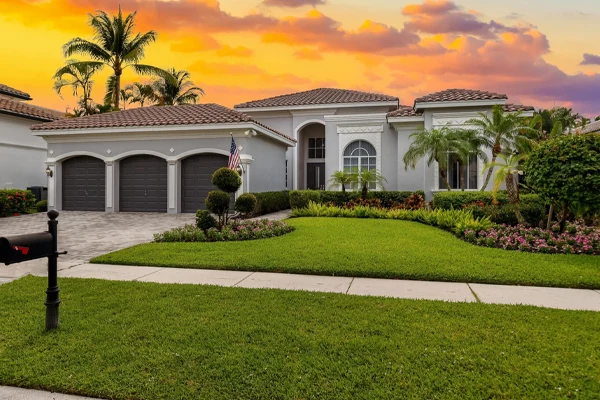 fresh-cut-cape-coral-home A large red home with a freshly cut lawn with the cross hatching design.
