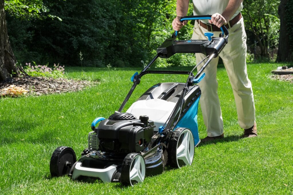Cape Coral lawn being mowed using eco-friendly lawn care practices with healthy green grass.