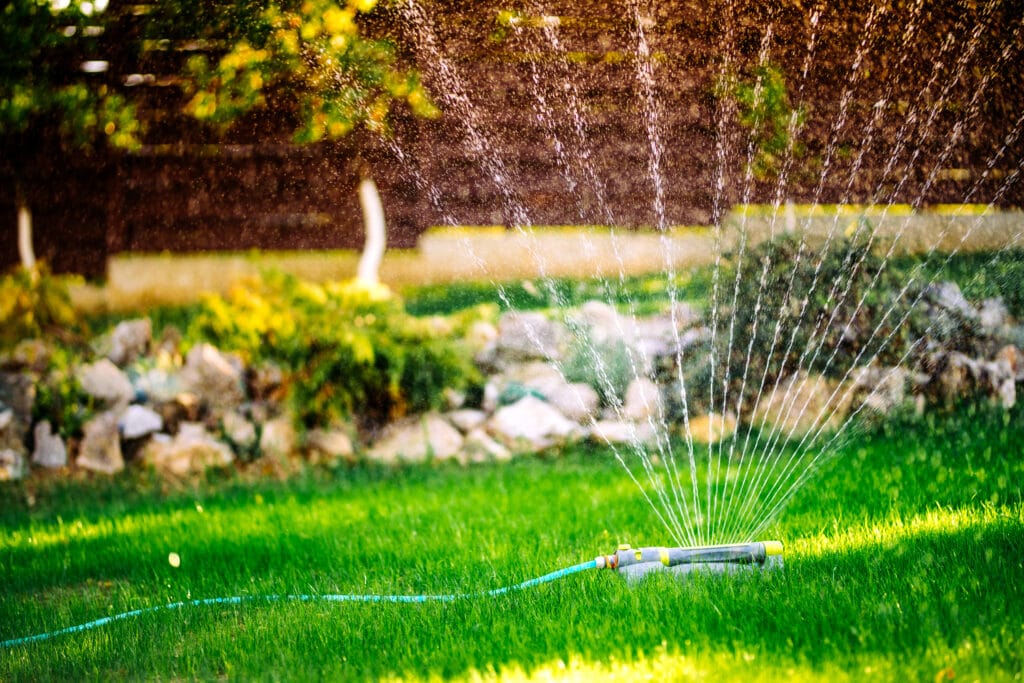 Cape Coral lawn with sprinkler system and drip irrigation system watering plants efficiently.